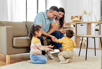 Image showing portrait of happy family sitting on sofa at home