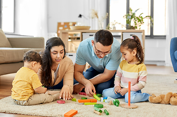 Image showing happy family palying with wooden toys at home