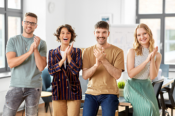 Image showing happy business team applauding at office