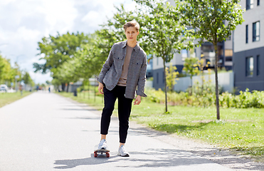 Image showing teenage boy on skateboard on city street