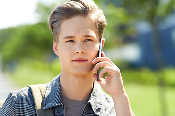 Image showing teenage student boy calling on smartphone in city