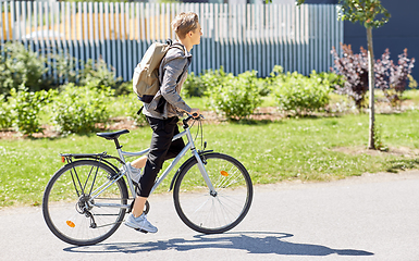 Image showing young man riding bicycle on city street