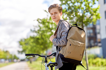 Image showing young man with bicycle and backpack on city street