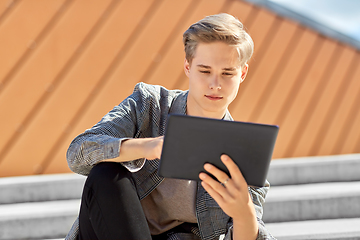 Image showing young manor teenage boy with tablet pc in city