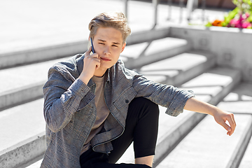 Image showing teenage boy calling on smartphone in city