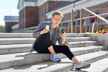 Image showing teenage boy with drink and smartphone in city