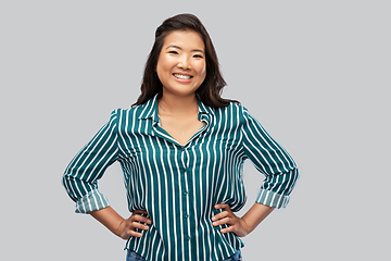 Image showing happy asian woman over grey background