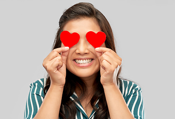 Image showing happy asian woman covering her eyes with red heart