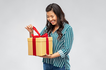 Image showing happy asian woman opening gift box