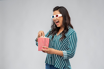 Image showing asian woman in 3d movie glasses eating popcorn