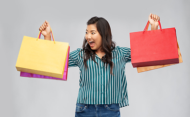 Image showing happy asian woman with shopping bags