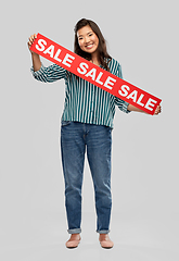 Image showing happy smiling young asian woman with sale banner