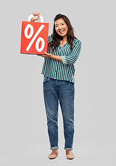 Image showing asian woman with percentage sign on shopping bags