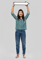 Image showing happy smiling asian woman with rightwards arrow