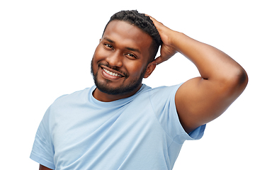 Image showing happy african american man touching his hair