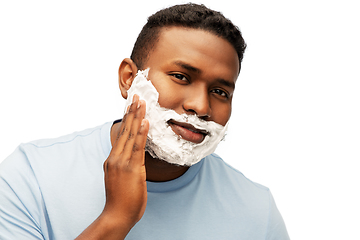 Image showing african american man applying shaving foam to face