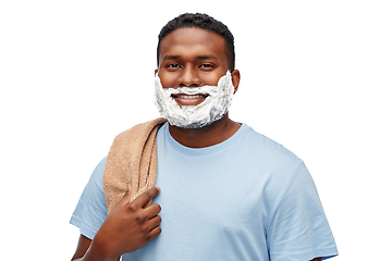 Image showing smiling african man with shaving cream and towel