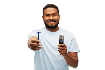 Image showing smiling african man with razor blade and trimmer