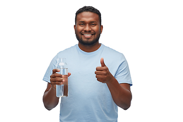 Image showing happy african man with water in glass bottle