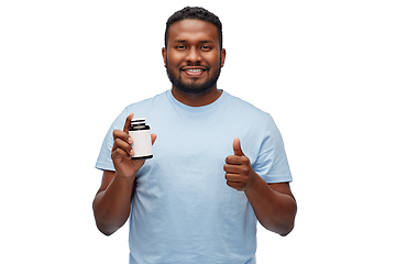 Image showing african man with medicine showing thumbs up