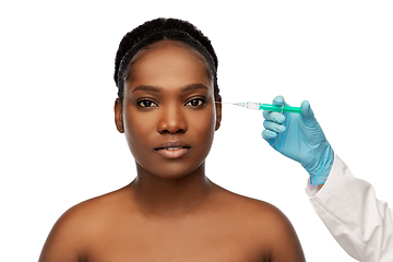 Image showing african woman and hand in glove with syringe