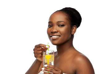 Image showing african american woman with glass of fruit water