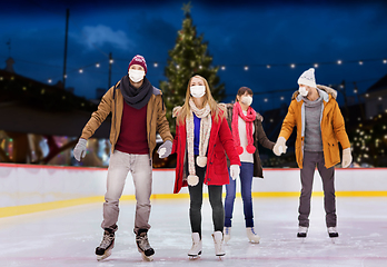 Image showing friends in masks on christmas skating rink