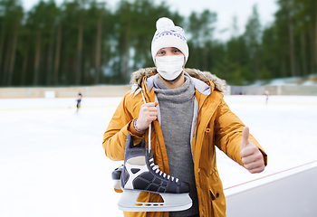 Image showing man in mask showing thumbs up on skating rink