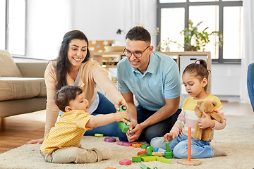 Image showing happy family palying with wooden toys at home