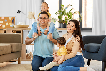 Image showing portrait of happy family sitting on sofa at home