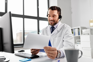 Image showing happy doctor with computer and headset at hospital