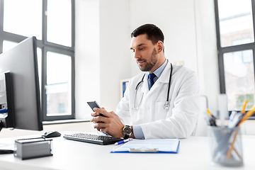 Image showing male doctor with smartphone at hospital