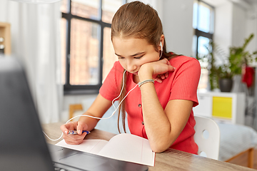 Image showing student girl in earphones learning at home