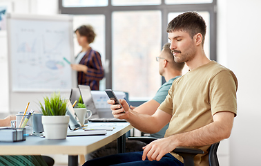 Image showing man with smartphone at office conference