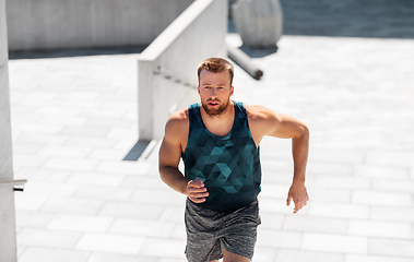 Image showing young man running upstairs