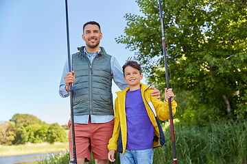 Image showing happy smiling father and son fishing on river