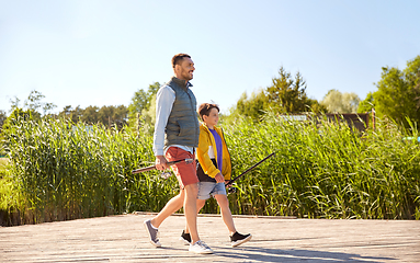 Image showing happy smiling father and son fishing on river