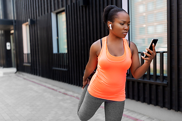 Image showing african woman with smartphone exercising outdoors