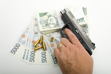 Image showing gun and czech banknotes, crime concept