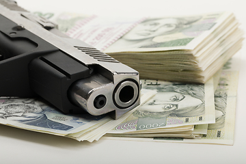 Image showing gun and czech banknotes, crime concept