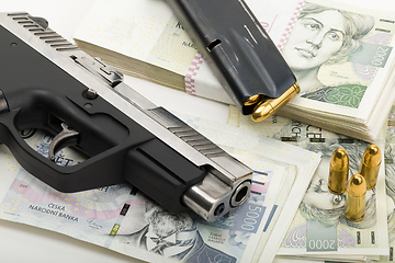 Image showing gun and czech banknotes, crime concept