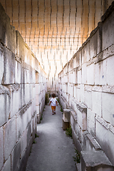 Image showing Lonely young boy walking in a corridor