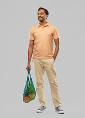 Image showing happy indian man with food in reusable net tote