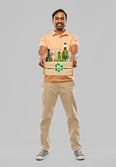 Image showing smiling young indian man sorting glass waste