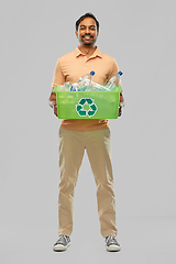 Image showing smiling young indian man sorting plastic waste