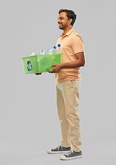 Image showing smiling young indian man sorting plastic waste