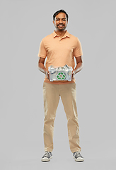 Image showing smiling young indian man sorting metallic waste