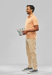 Image showing smiling young indian man sorting metallic waste