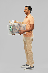 Image showing smiling young indian man sorting paper waste