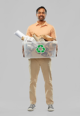 Image showing smiling young indian man sorting paper waste